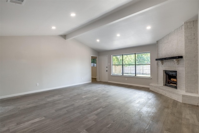 unfurnished living room featuring lofted ceiling with beams, dark hardwood / wood-style floors, and a brick fireplace