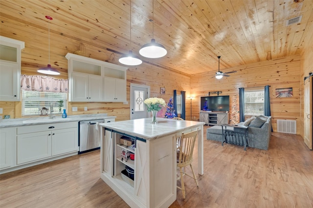 kitchen featuring white cabinets, dishwasher, sink, and decorative light fixtures