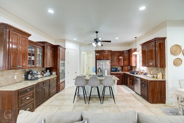 kitchen with a kitchen bar, decorative backsplash, stainless steel appliances, a center island, and hanging light fixtures