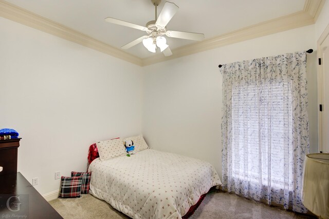 carpeted bedroom featuring crown molding and ceiling fan