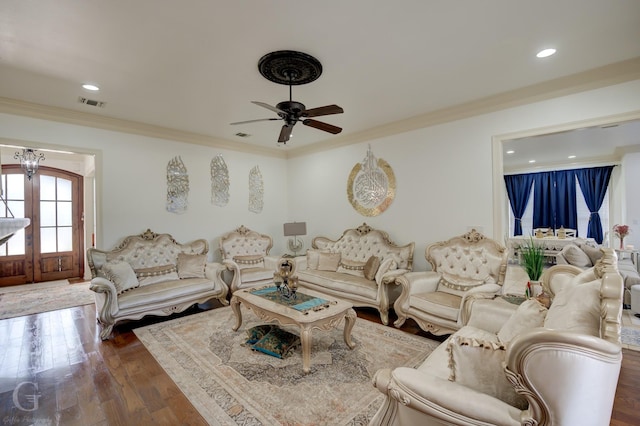 living room with dark wood-type flooring, ceiling fan, ornamental molding, and french doors