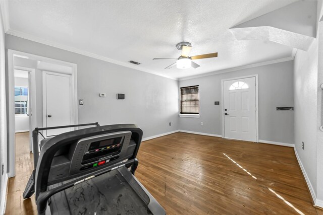 interior space with a textured ceiling, dark hardwood / wood-style floors, ceiling fan, and crown molding