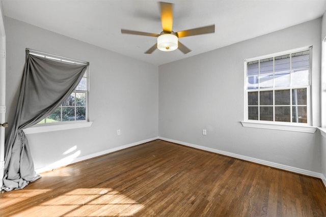 spare room featuring ceiling fan and dark wood-type flooring