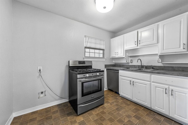 kitchen with sink, white cabinets, a textured ceiling, and appliances with stainless steel finishes