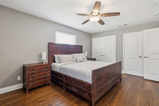 bedroom with dark hardwood / wood-style floors and ceiling fan