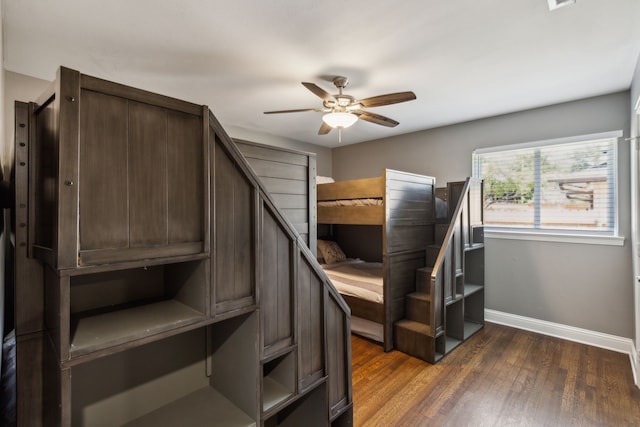 unfurnished bedroom featuring dark wood-type flooring and ceiling fan