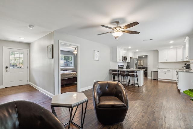 living room featuring dark hardwood / wood-style floors, sink, and a wealth of natural light