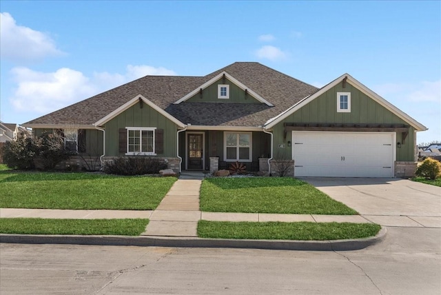 craftsman house featuring a front yard and a garage