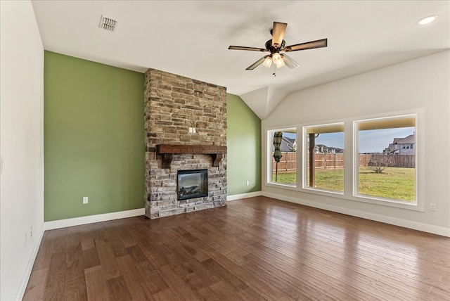 unfurnished living room with ceiling fan, wood-type flooring, a stone fireplace, and vaulted ceiling