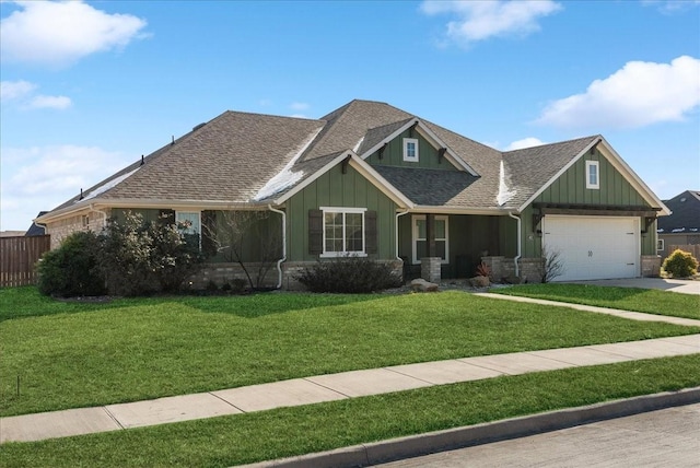 craftsman-style home featuring a front yard and a garage