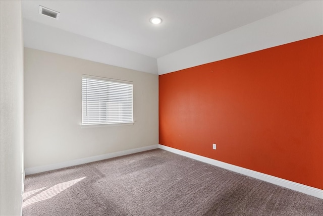 empty room featuring carpet floors and lofted ceiling