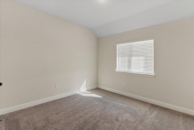 empty room featuring carpet floors and lofted ceiling