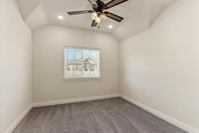 carpeted empty room featuring ceiling fan and vaulted ceiling