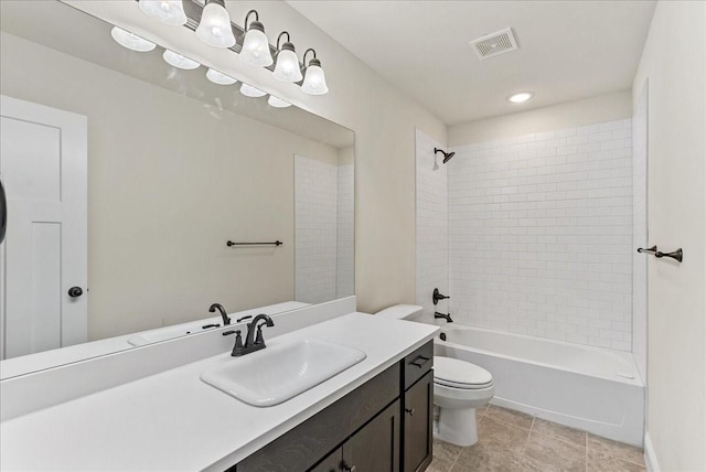 full bathroom with toilet, tiled shower / bath, and vanity