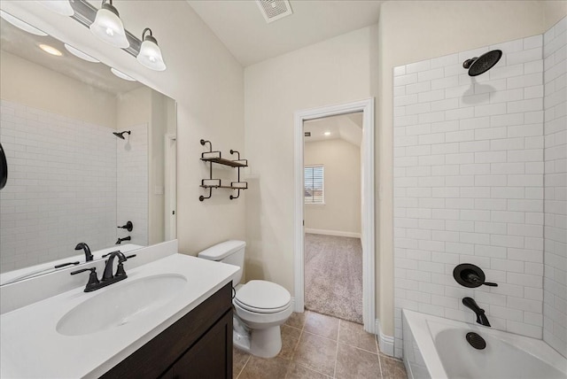 full bathroom featuring toilet, tiled shower / bath, tile patterned flooring, and vanity