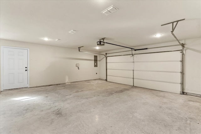 garage featuring electric panel and a garage door opener