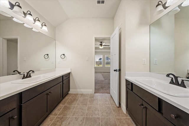 bathroom with ceiling fan, vaulted ceiling, vanity, and tile patterned flooring