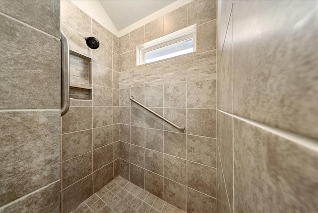 interior details featuring a tile shower