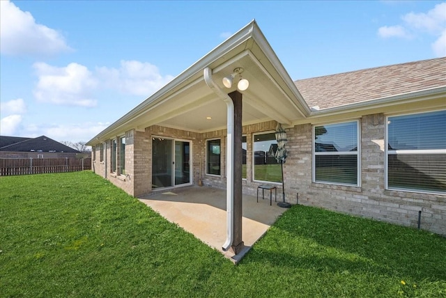 rear view of property featuring a patio area and a yard