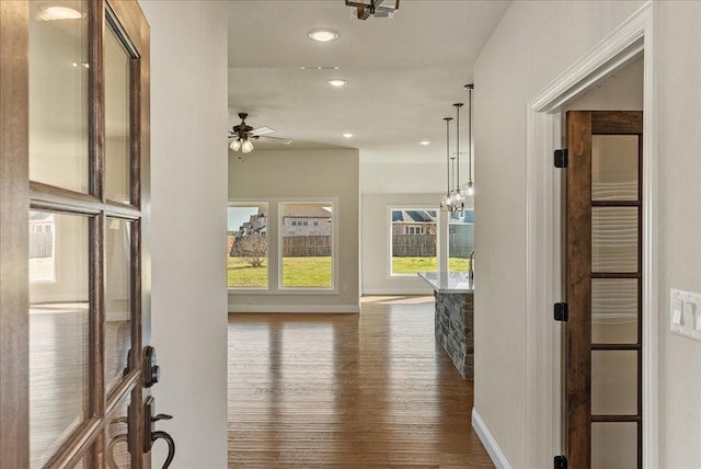 hall featuring a notable chandelier and dark hardwood / wood-style flooring