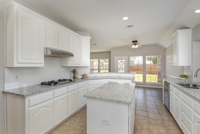 kitchen featuring kitchen peninsula, sink, a kitchen island, and appliances with stainless steel finishes