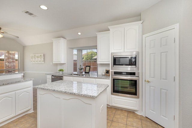 kitchen with white cabinets, a center island, sink, and appliances with stainless steel finishes