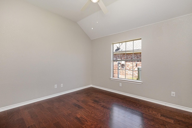 empty room with ceiling fan, wood-type flooring, and vaulted ceiling