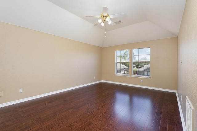 spare room featuring ceiling fan, dark wood-type flooring, and vaulted ceiling