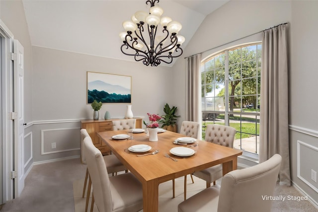 dining room featuring carpet, a chandelier, and vaulted ceiling