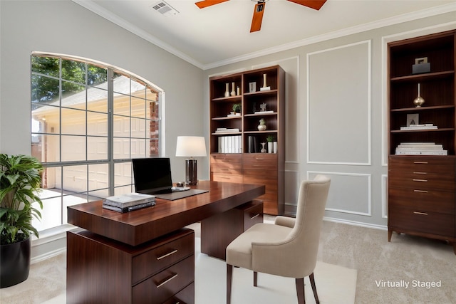 carpeted home office featuring ceiling fan and ornamental molding