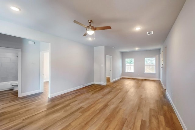 unfurnished living room featuring ceiling fan and light wood-type flooring
