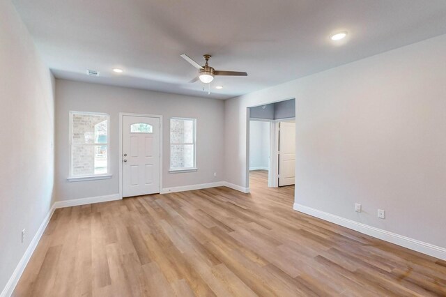 foyer entrance with ceiling fan and light hardwood / wood-style floors