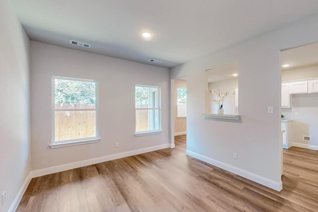 empty room with light hardwood / wood-style floors