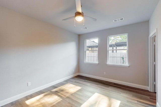 empty room featuring ceiling fan and light hardwood / wood-style flooring