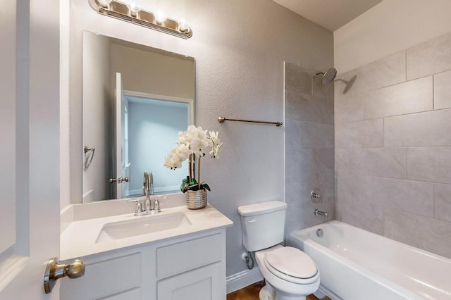 full bathroom with vanity, toilet, and tiled shower / bath combo