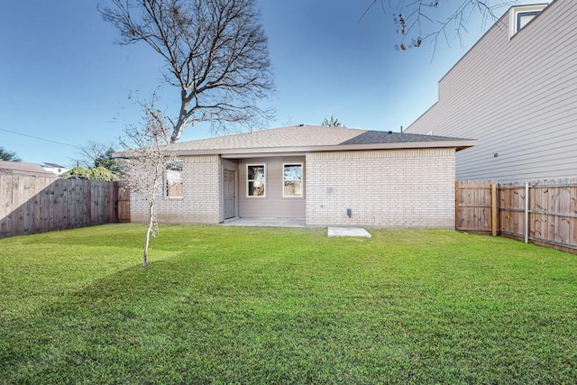 rear view of house featuring a lawn