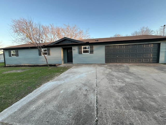 single story home featuring a garage and a front lawn