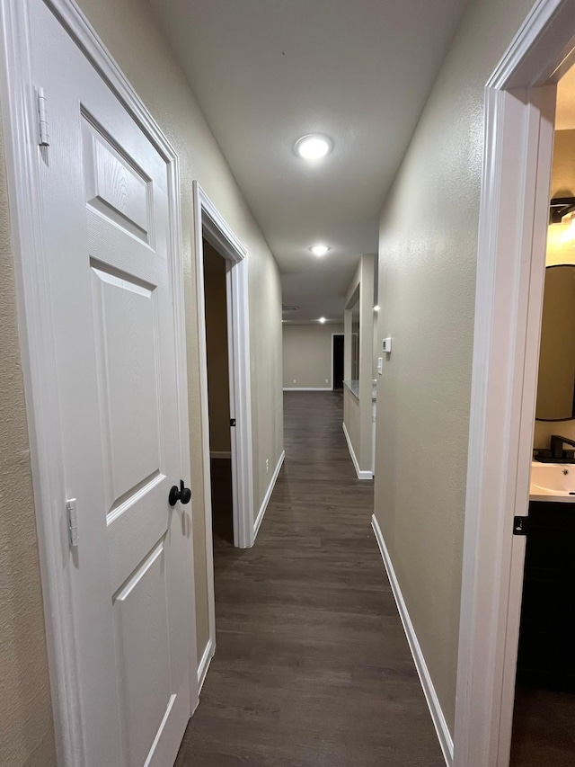 hallway featuring dark hardwood / wood-style flooring