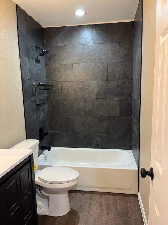 full bathroom featuring toilet, vanity, tiled shower / bath combo, and hardwood / wood-style flooring