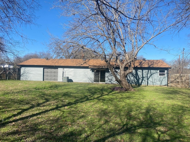 rear view of property with a lawn