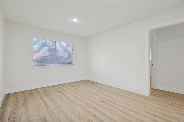 spare room with light hardwood / wood-style floors