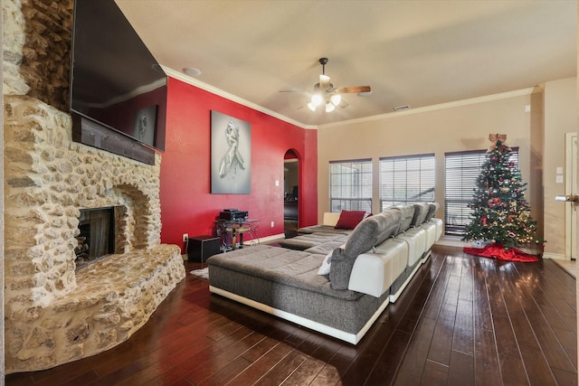 living room with ceiling fan, a fireplace, dark hardwood / wood-style floors, and crown molding