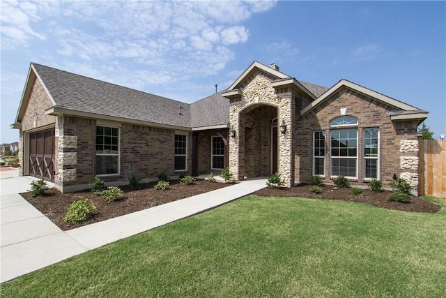 view of front of property featuring a front yard and a garage