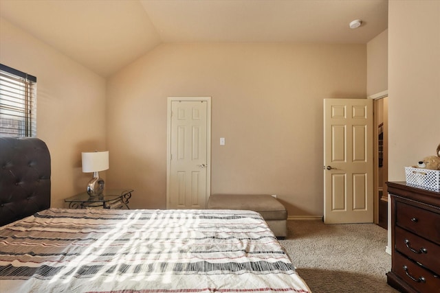 carpeted bedroom featuring lofted ceiling