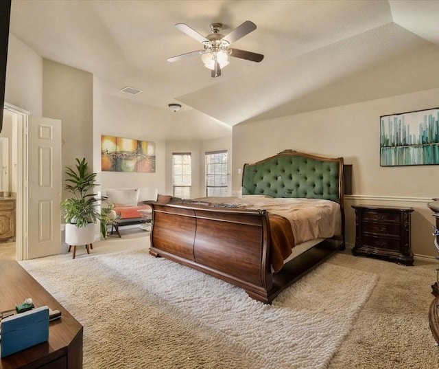 carpeted bedroom with ceiling fan and vaulted ceiling