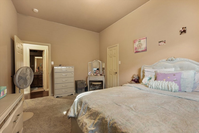 bedroom featuring vaulted ceiling and dark colored carpet