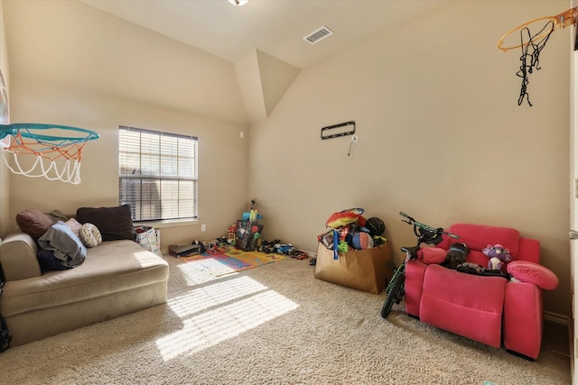 playroom with vaulted ceiling and carpet flooring