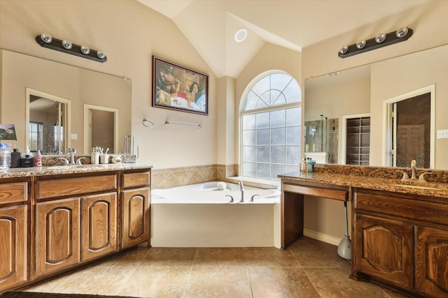 bathroom featuring lofted ceiling, vanity, and a wealth of natural light