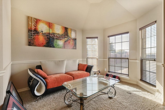 living area featuring lofted ceiling and carpet floors