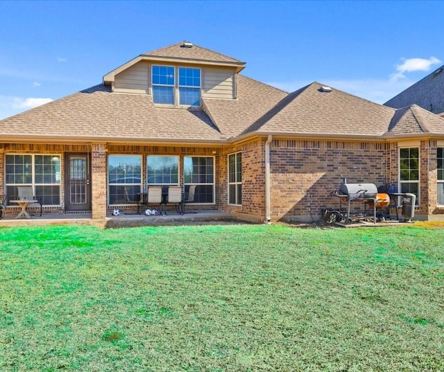 rear view of house with a yard and a patio area